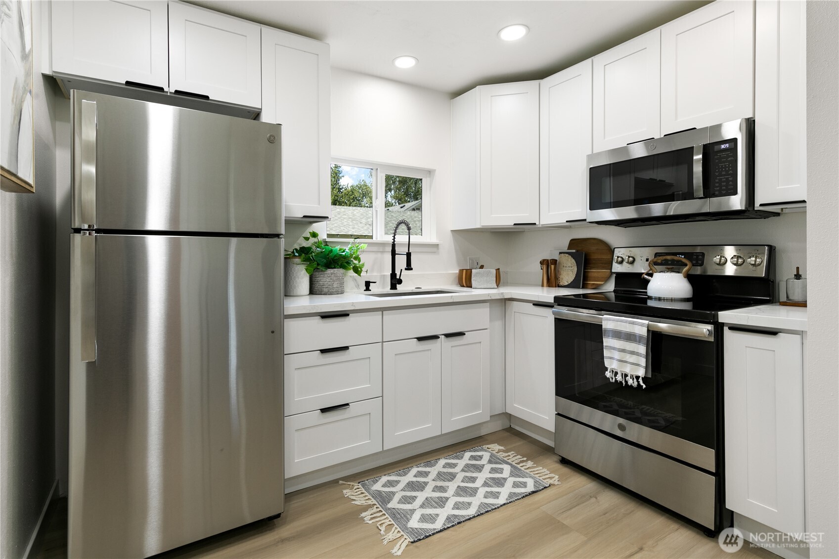 11 Southwest 100th Street Seattle, WA 98146 - Photo 26 of 36 a kitchen with a refrigerator stove and microwave
