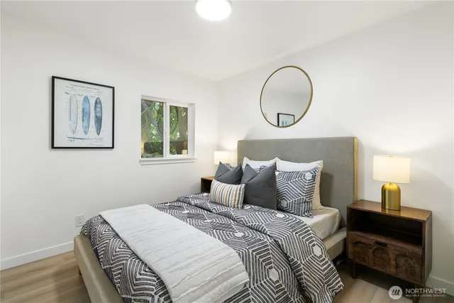 a bedroom with a bed and a lamp