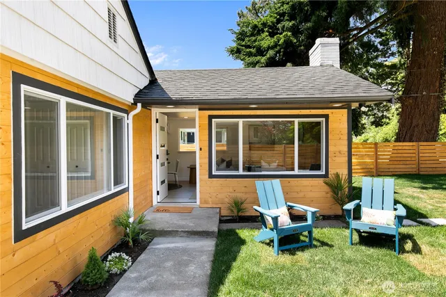 a view of a house with backyard sitting area and garden