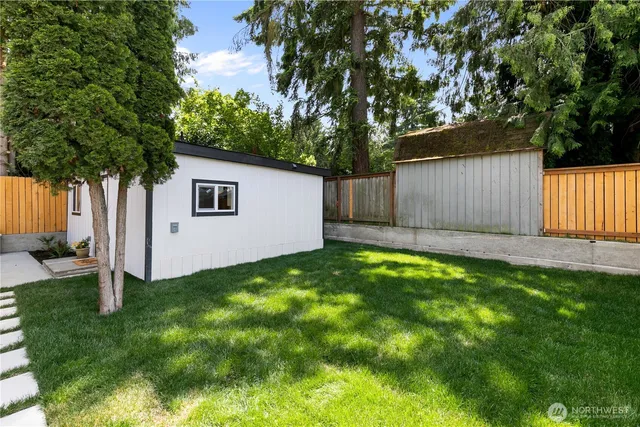 a view of a backyard with a tree