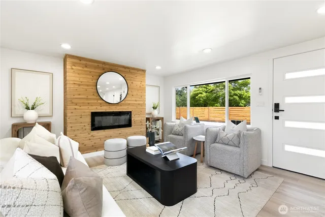 a living room with furniture a large window and a fireplace