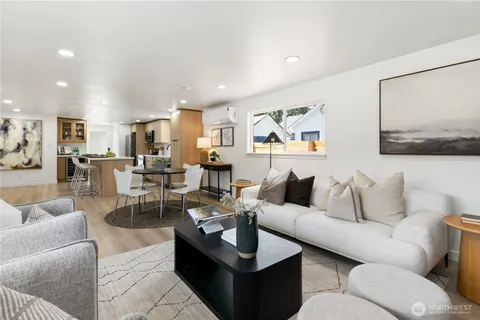 a living room with furniture and view of kitchen