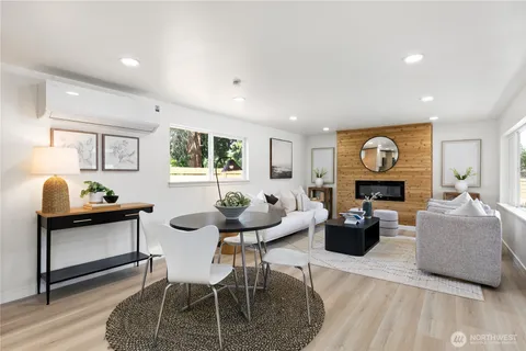 a living room with fireplace furniture and a wooden floor
