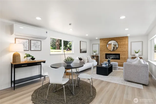 a living room with fireplace furniture and a wooden floor
