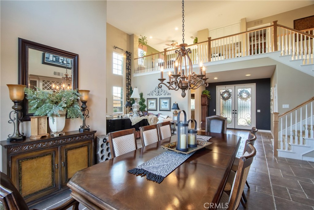 32815 Cleveland Street Temecula, CA 92592 - Photo 13 of 71 a view of a dining room with furniture a potted plant and wooden floor
