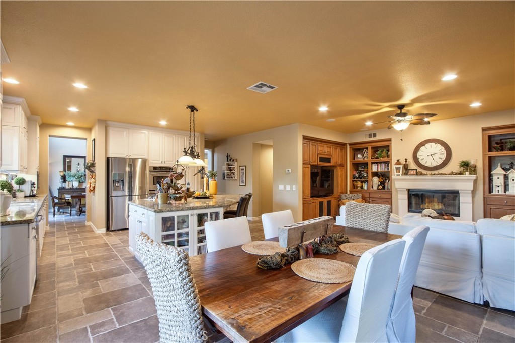 32815 Cleveland Street Temecula, CA 92592 - Photo 15 of 71 a living room with furniture a fireplace and a open kitchen view