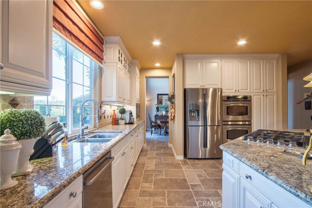 32815 Cleveland Street Temecula, CA 92592 - Photo 19 of 71 a kitchen with stainless steel appliances granite countertop a refrigerator a sink a stove and island