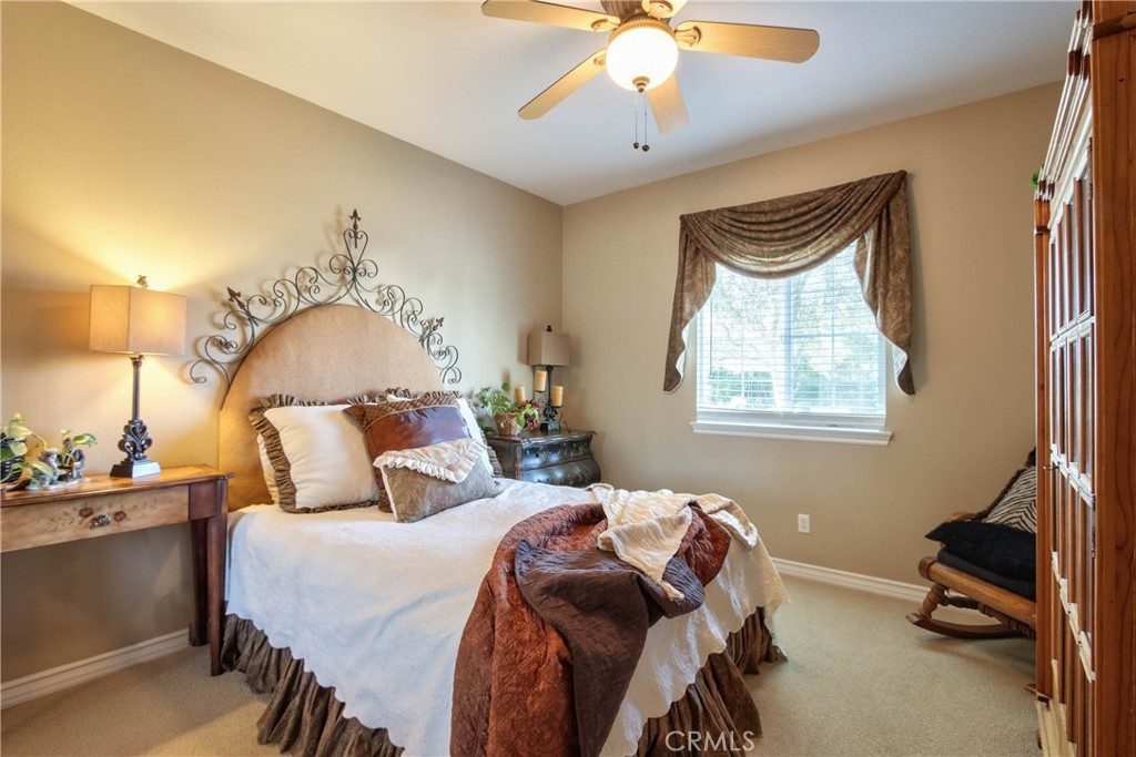 32815 Cleveland Street Temecula, CA 92592 - Photo 25 of 71 a bedroom with a bed and a chandelier