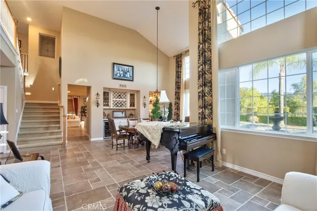 a bedroom with a bed a chandelier and a couch