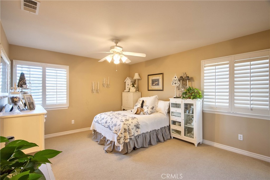 32815 Cleveland Street Temecula, CA 92592 - Photo 35 of 71 a bedroom with a bed and a chandelier