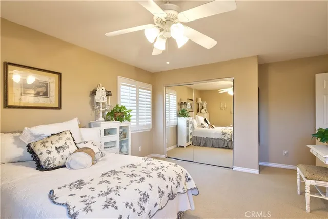 a view of a patio with couches table and chairs under an umbrella with a garden