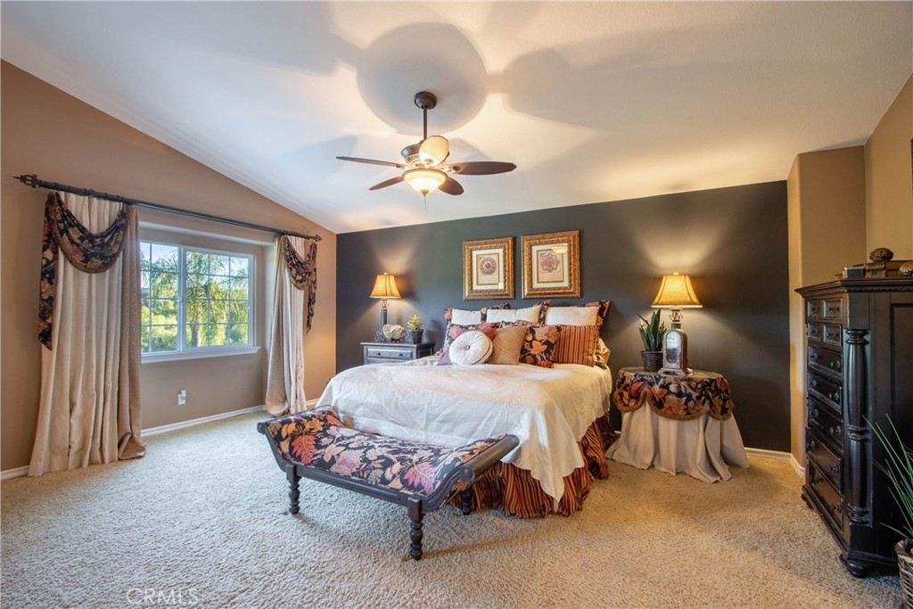 32815 Cleveland Street Temecula, CA 92592 - Photo 40 of 71 a bedroom with a bed a chandelier and a couch