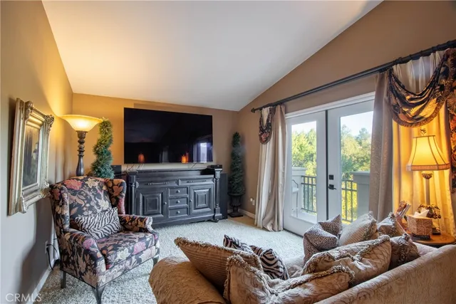 a view of a swimming pool with sitting area and furniture
