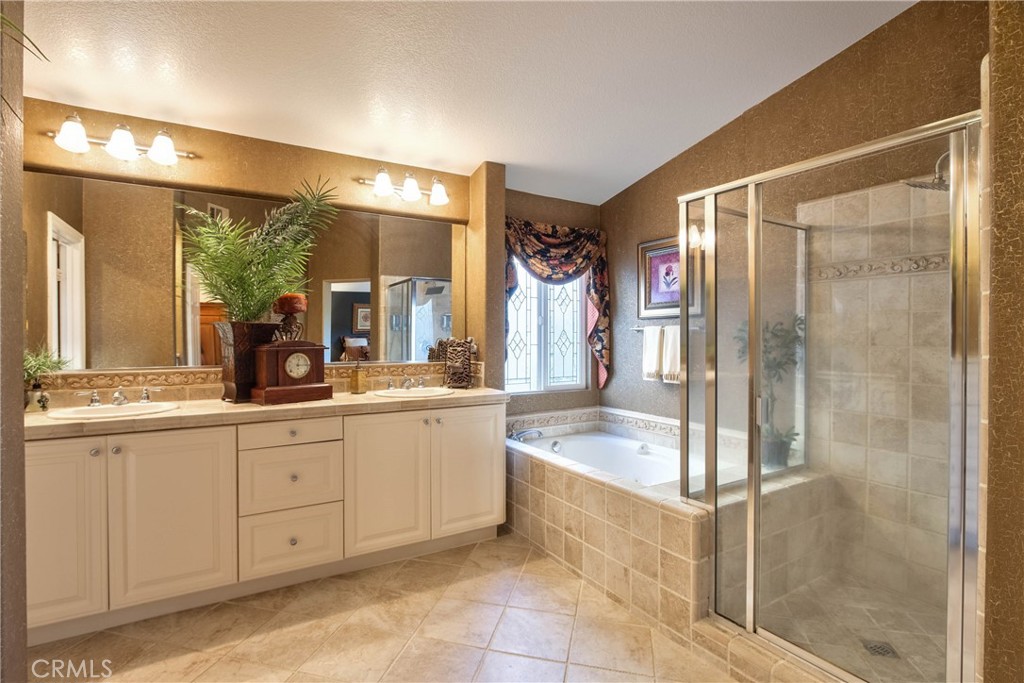 32815 Cleveland Street Temecula, CA 92592 - Photo 45 of 71 a spacious bathroom with a granite countertop sink mirror and a bathtub