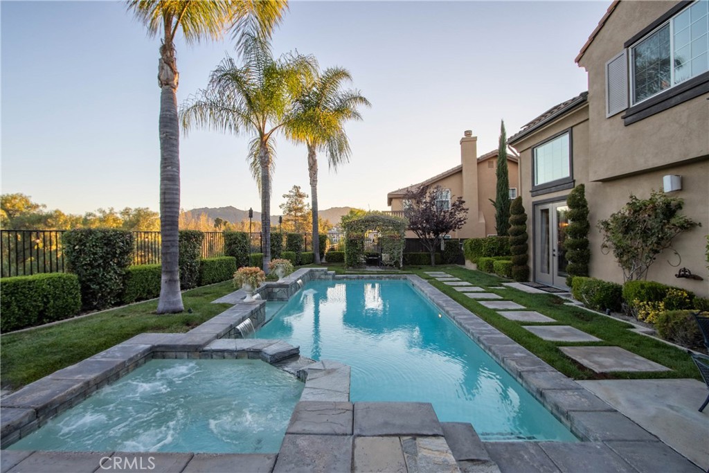 32815 Cleveland Street Temecula, CA 92592 - Photo 47 of 71 a view of a swimming pool with a yard and palm trees