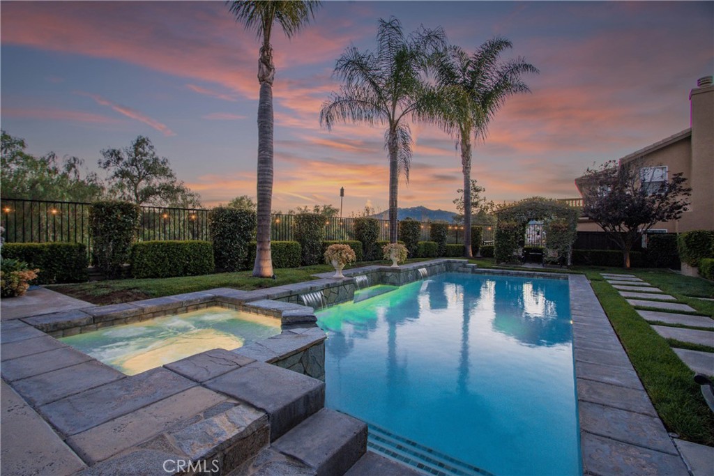 32815 Cleveland Street Temecula, CA 92592 - Photo 62 of 71 a view of a swimming pool with a table and chairs