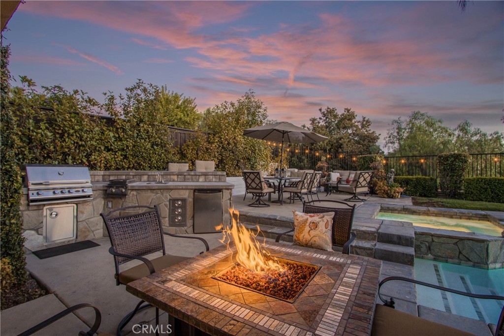 32815 Cleveland Street Temecula, CA 92592 - Photo 63 of 71 a view of a patio with table and chairs floor to ceiling window and outdoor kitchen