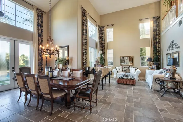 a view of a dining room with furniture and chandelier