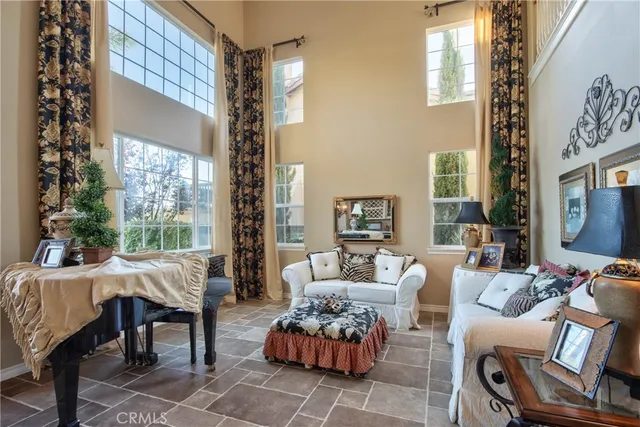 a view of a dining room with furniture a potted plant and wooden floor