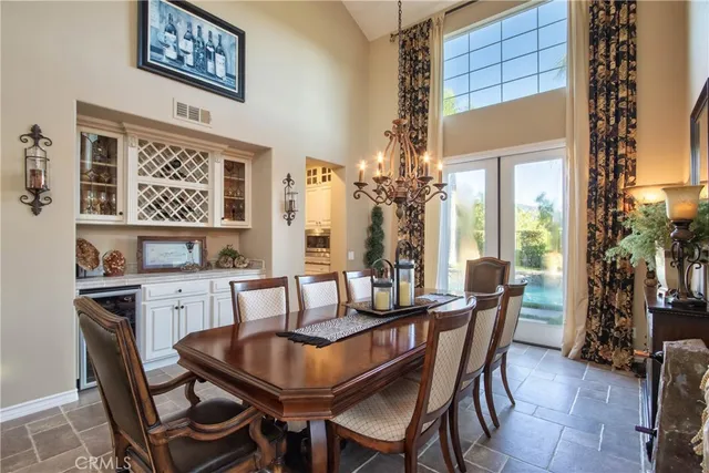 a view of a dining room with furniture and a chandelier