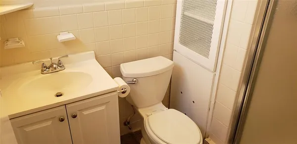 a white toilet sitting next to a bathroom sink