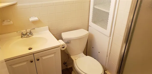 a white toilet sitting next to a bathroom sink