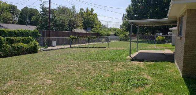 a view of backyard with small cabin