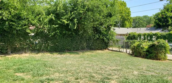 a view of yard with swimming pool and green space