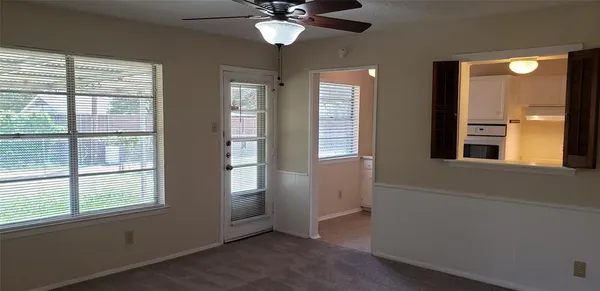 an empty room with windows and closet