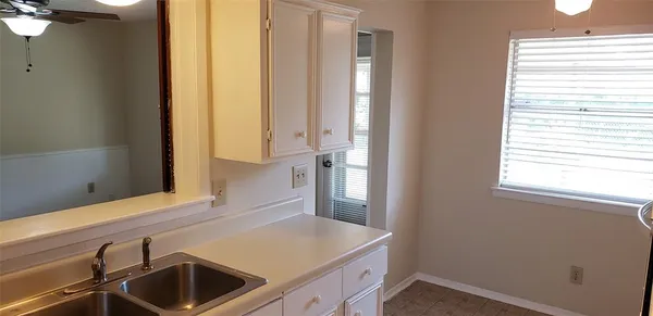 a kitchen with a sink and a window