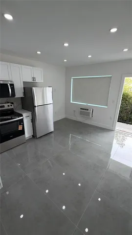 a view of kitchen with stainless steel appliances a refrigerator and a stove top oven