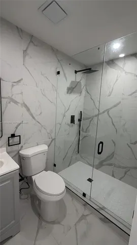a bathroom with a toilet and a shower