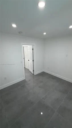 an empty room with a empty space and windows