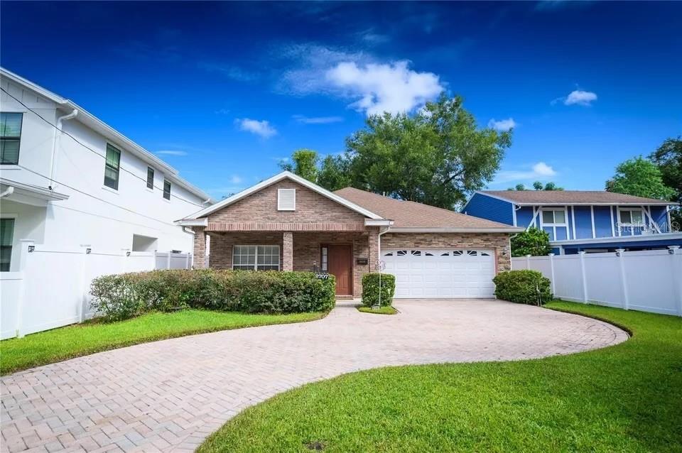 2707 Kilgore Street Orlando, FL 32803 - Photo 1 of 9 a front view of a house with a yard and potted plants