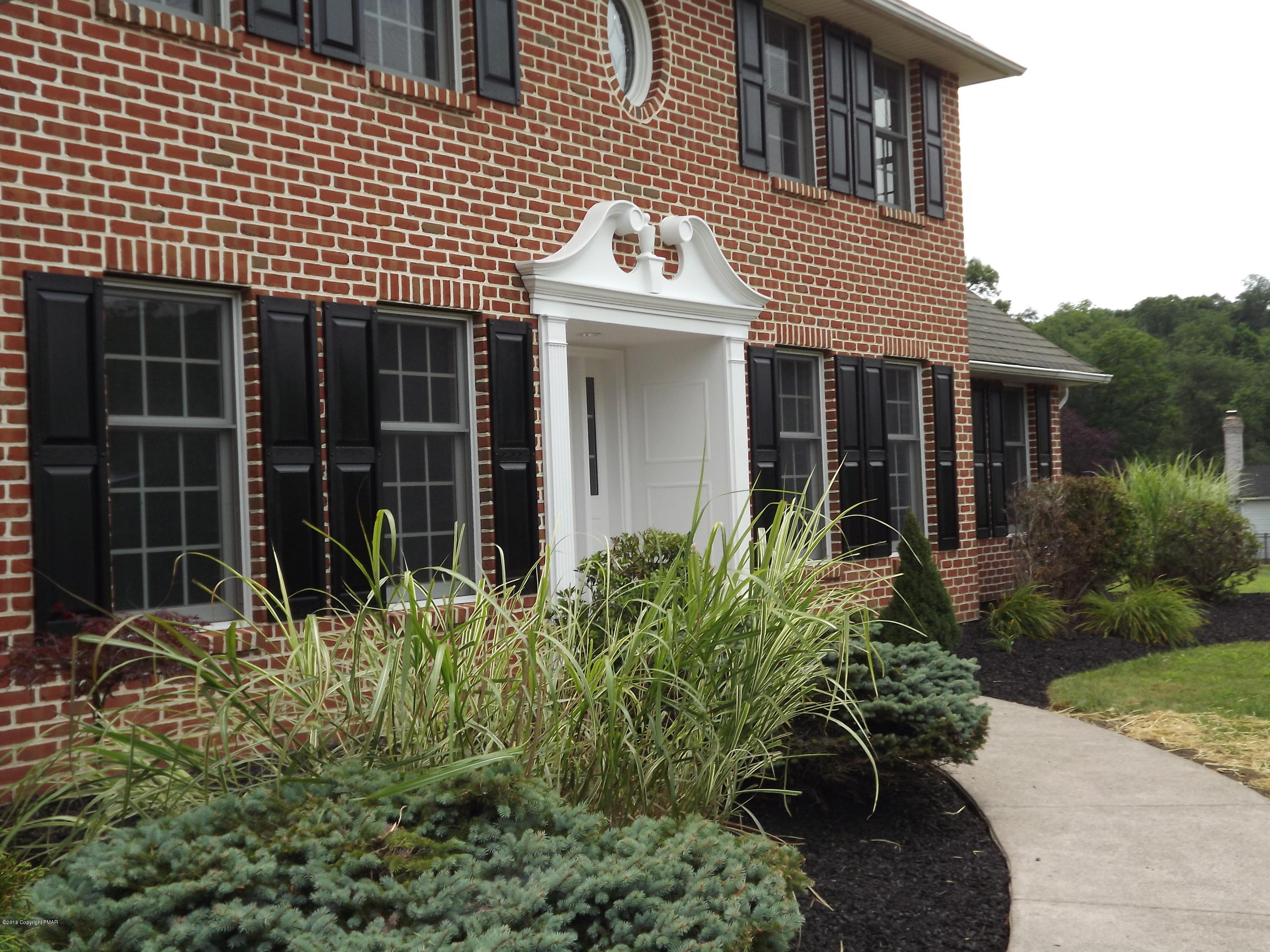2111 Fox Run Road Stroudsburg, PA 18360 - Photo 11 of 72 a view of a house with potted plants and a large window