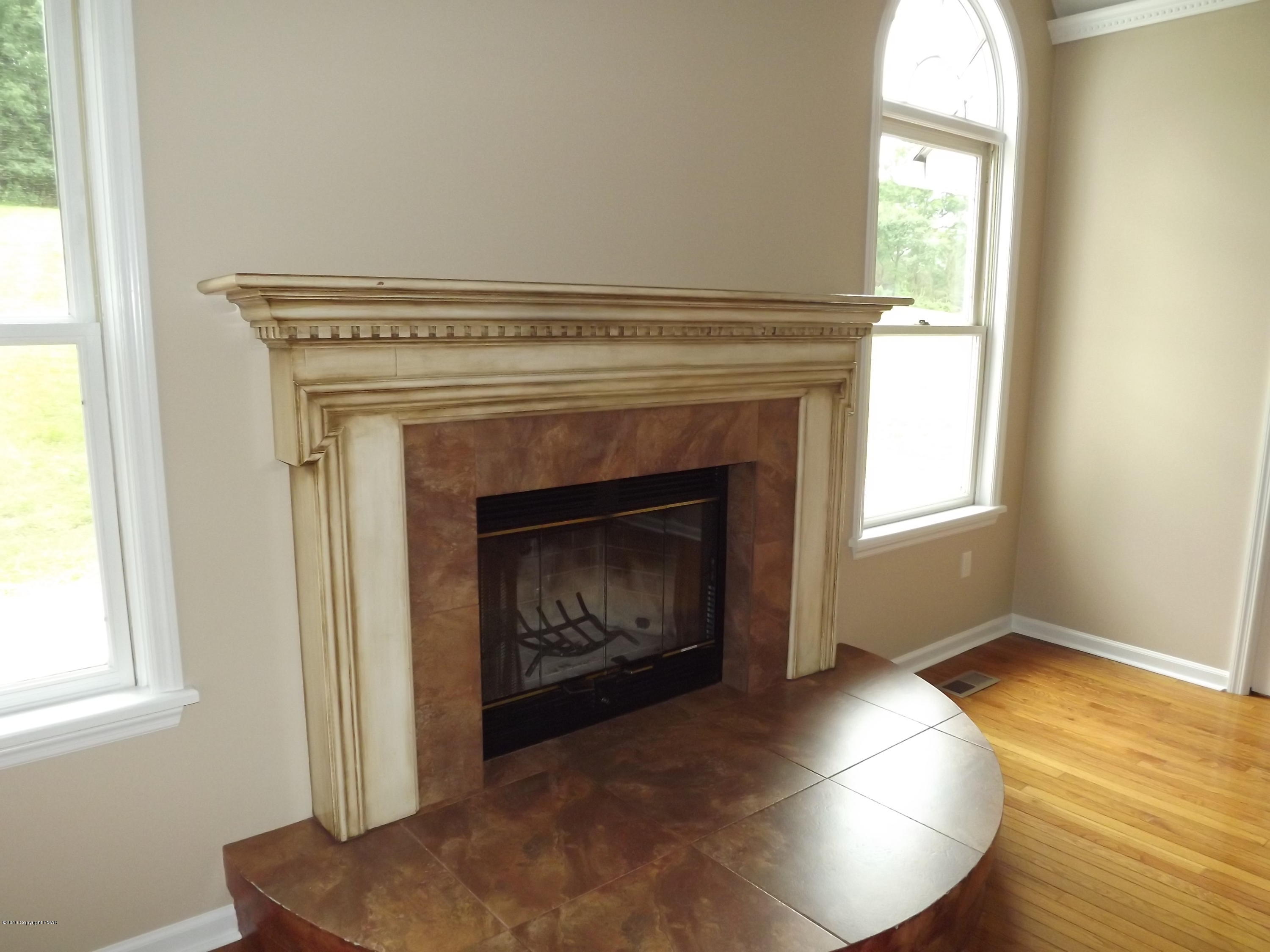2111 Fox Run Road Stroudsburg, PA 18360 - Photo 16 of 72 a living room with a fireplace and windows