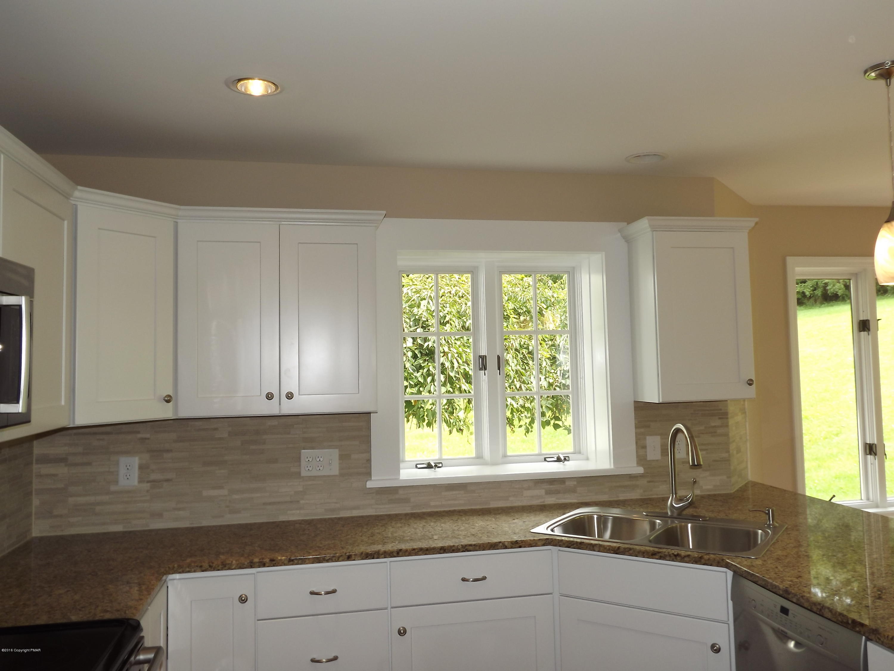 2111 Fox Run Road Stroudsburg, PA 18360 - Photo 21 of 72 a kitchen with granite countertop white cabinets and a window