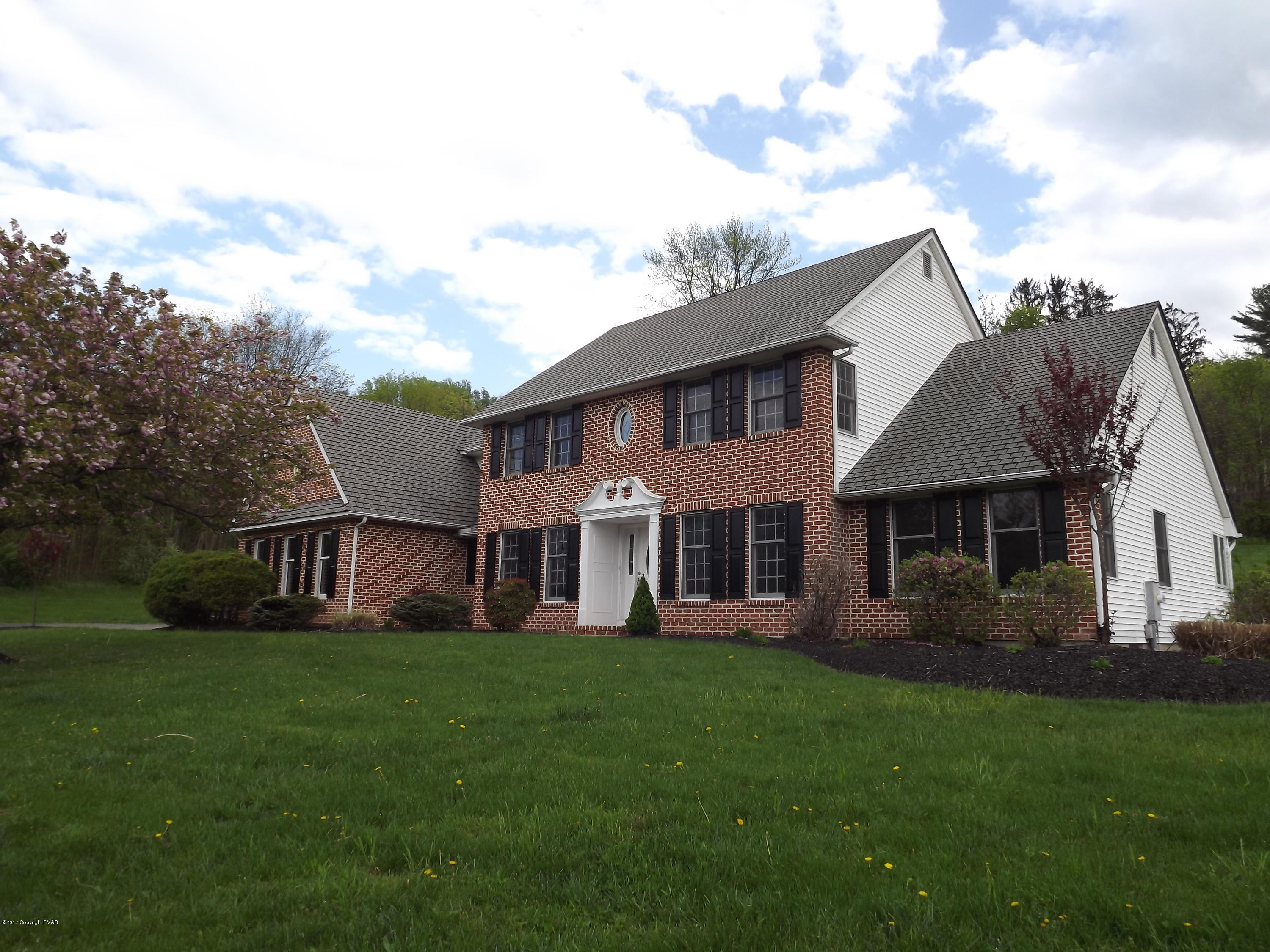 2111 Fox Run Road Stroudsburg, PA 18360 - Photo 4 of 72 a front view of a house with a garden and trees