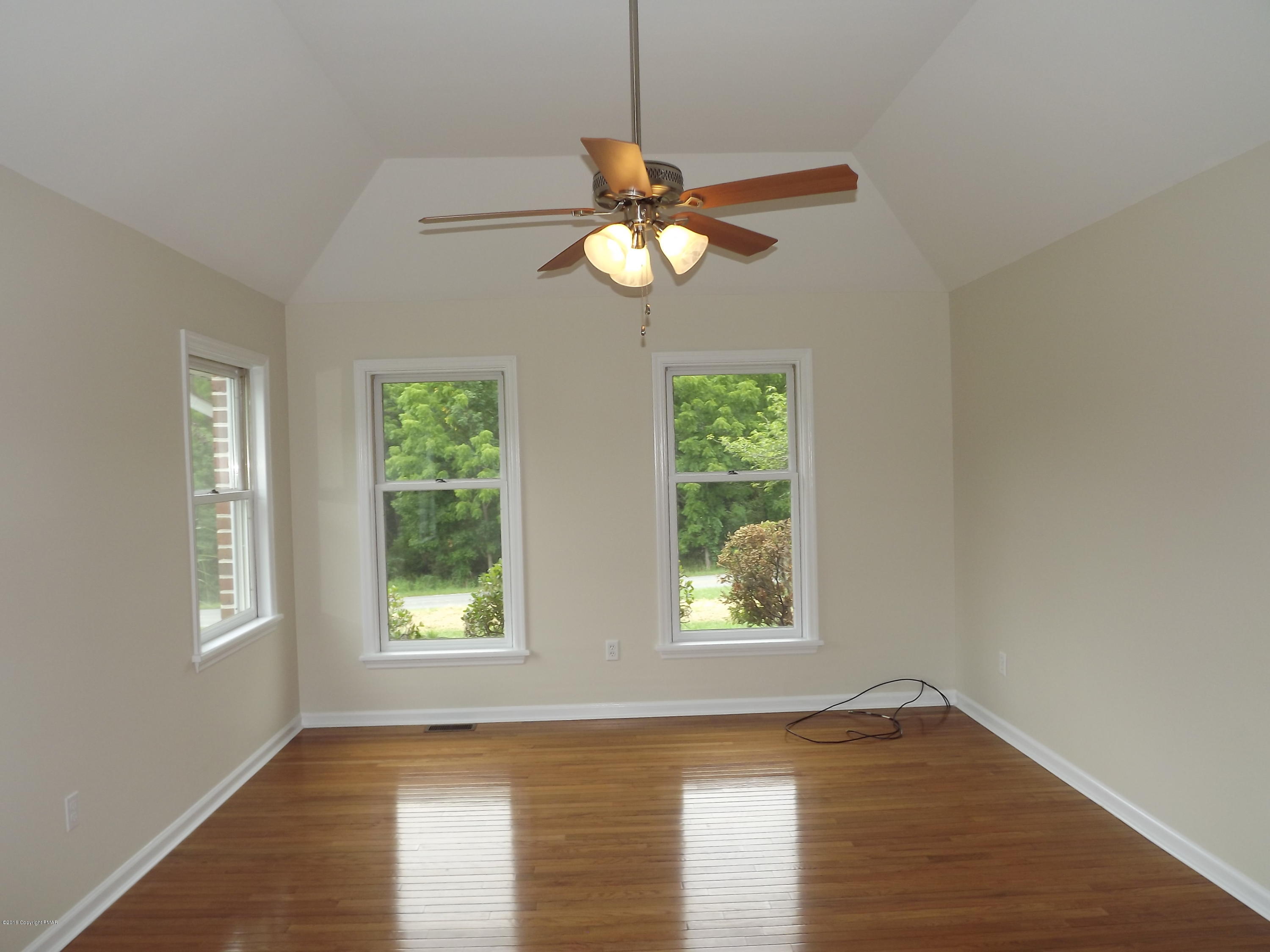 2111 Fox Run Road Stroudsburg, PA 18360 - Photo 44 of 72 a view of an empty room with window and wooden floor