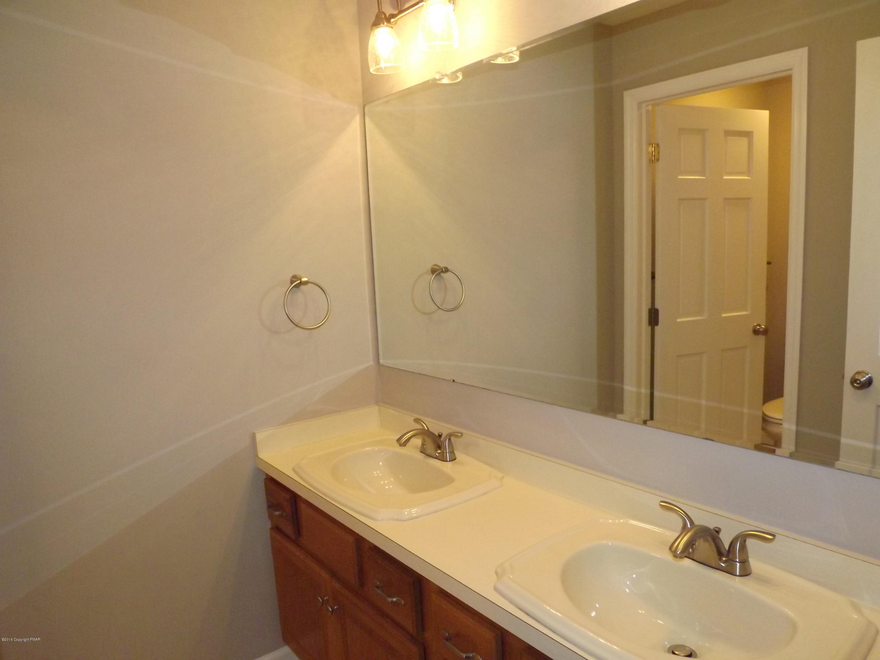 2111 Fox Run Road Stroudsburg, PA 18360 - Photo 58 of 72 a bathroom with a granite countertop sink and a mirror