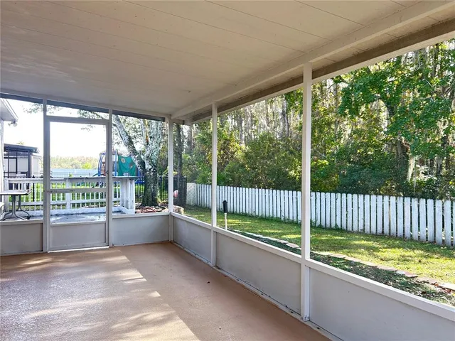 a view of deck with furniture and garden