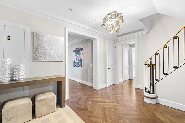 a kitchen with stainless steel appliances granite countertop a refrigerator a sink dishwasher a stove and white countertops with wooden floor