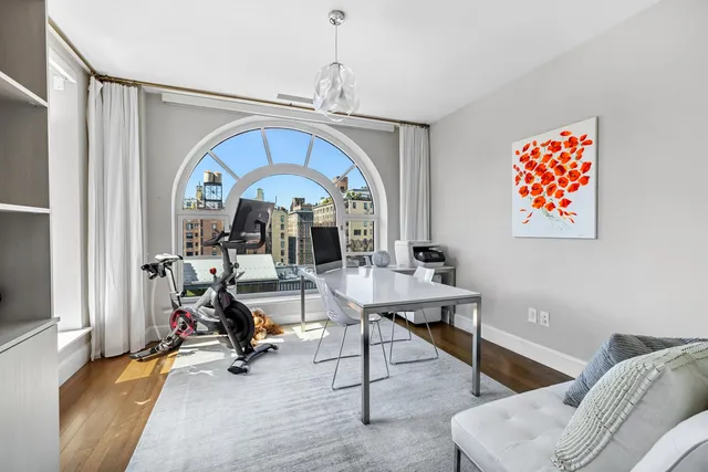 a living room with furniture and a floor to ceiling window