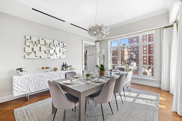 a view of a balcony with chairs and a potted plant