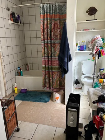 a bed room with furniture and a mirror