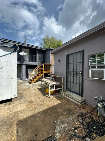 a view of a backyard with furniture and a garage