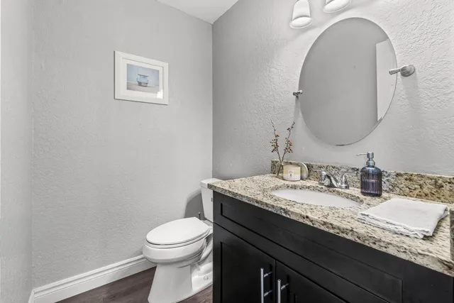 a bedroom with a bed a couch and a flat screen tv