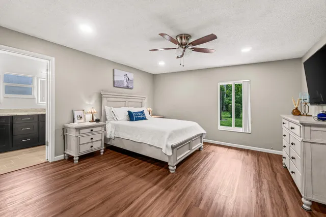 a bathroom with a granite countertop sink a toilet and shower