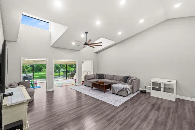a bathroom with a granite countertop sink a toilet and a mirror