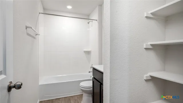 a bathroom with a shower and a toilet